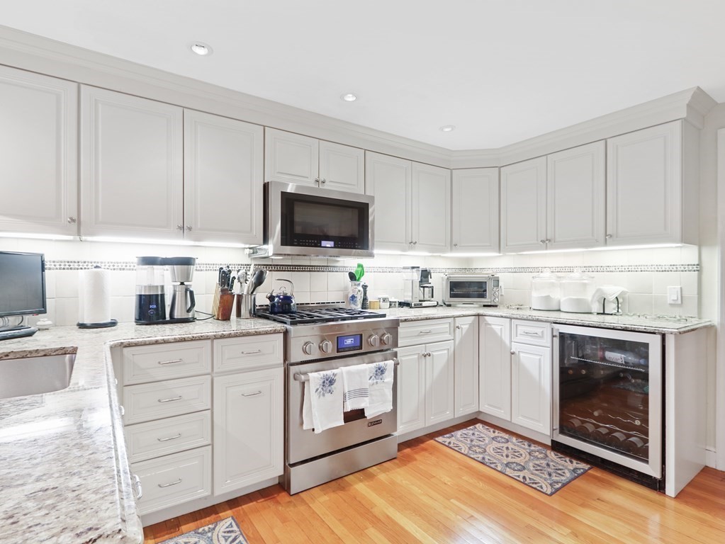 52 Beverly Road Wellesley, MA 02481 - Photo 4 of 41 a kitchen with granite countertop a stove top oven sink and cabinets