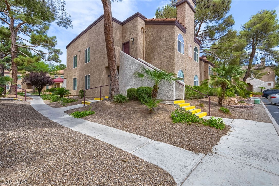9325 West Desert Inn Road, Unit 177 Las Vegas, NV 89117 - Photo 24 of 24 Mature trees and lush landscaping enhance the curb appeal of this stucco-finished building.