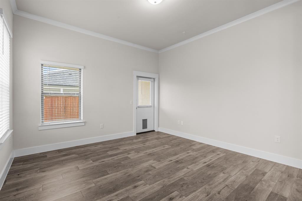 3274 Ganzer Road West, Unit 102B Denton, TX 76207 - Photo 15 of 22 an empty room with wooden floor and windows