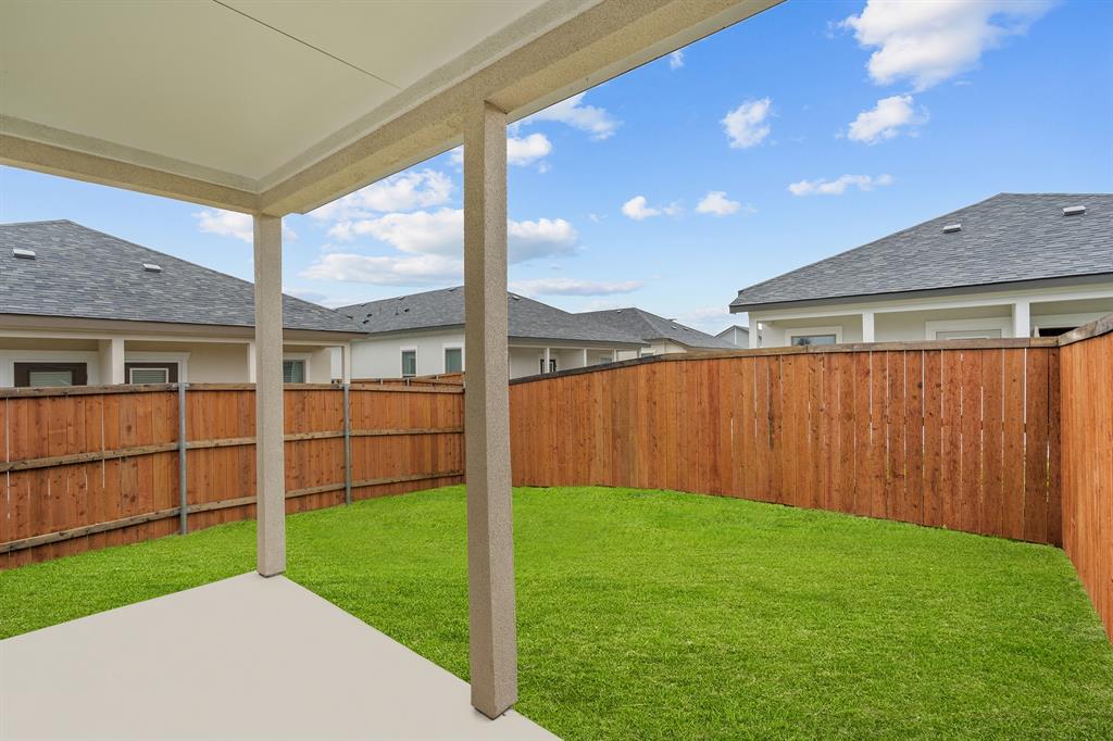 3274 Ganzer Road West, Unit 102B Denton, TX 76207 - Photo 19 of 22 a view of a backyard with plants and wooden fence