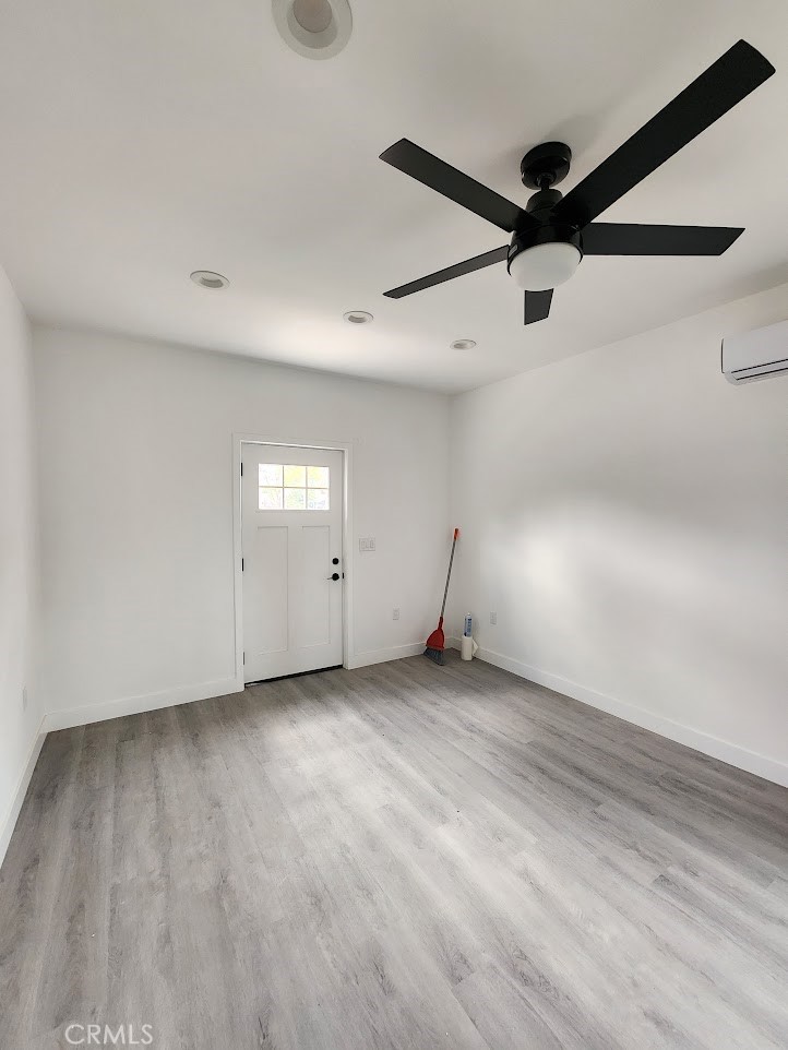 an empty room with a ceiling fan and window
