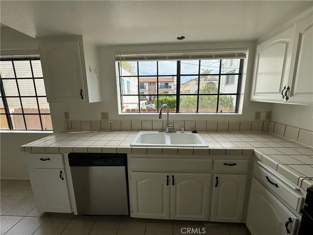 a view with cabinets a sink and a window