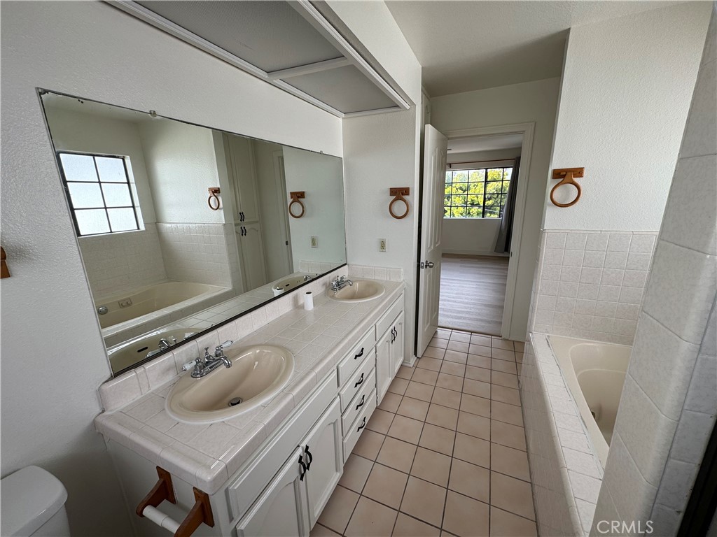 526 South Catalina Avenue, Unit C Redondo Beach, CA 90277 - Photo 13 of 29 a bathroom with a sink a toilet and mirror
