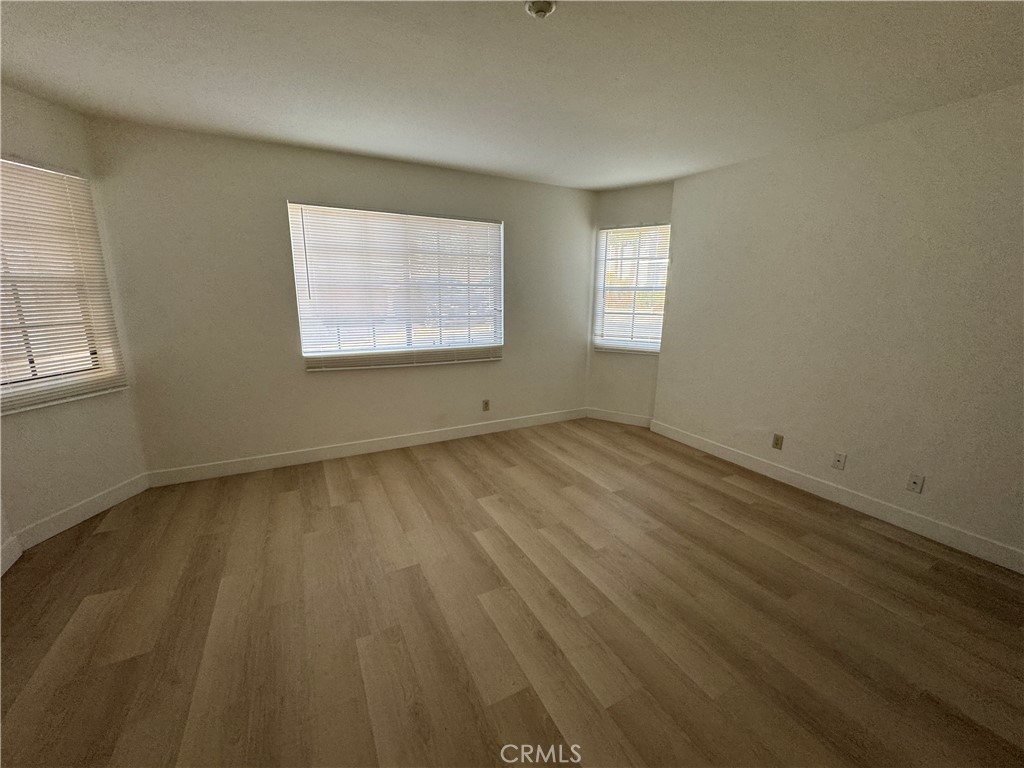 526 South Catalina Avenue, Unit C Redondo Beach, CA 90277 - Photo 19 of 29 an empty room with wooden floor and windows