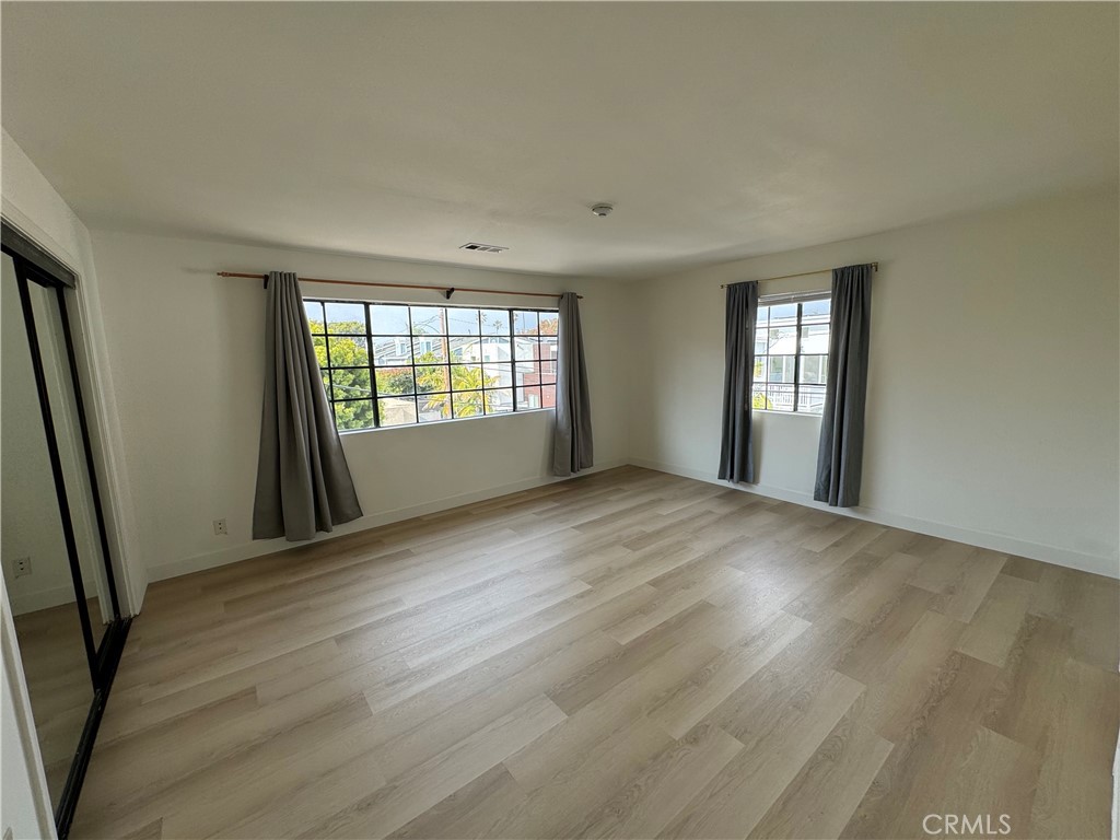 526 South Catalina Avenue, Unit C Redondo Beach, CA 90277 - Photo 3 of 29 an empty room with wooden floor and windows