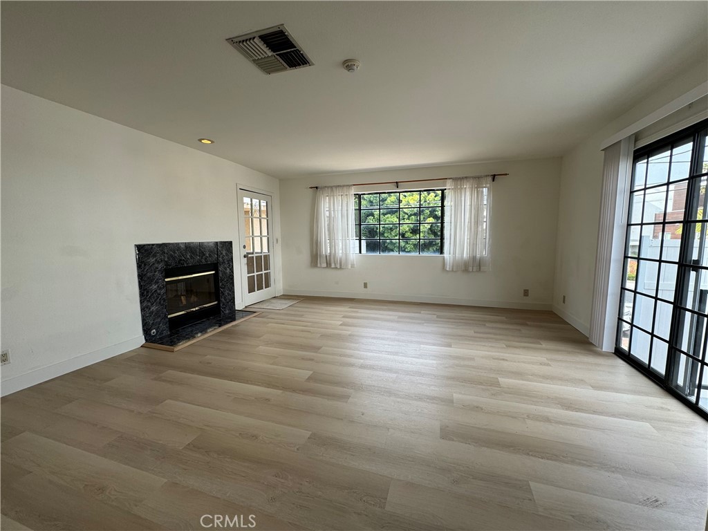 526 South Catalina Avenue, Unit C Redondo Beach, CA 90277 - Photo 7 of 29 an empty room with windows and fireplace