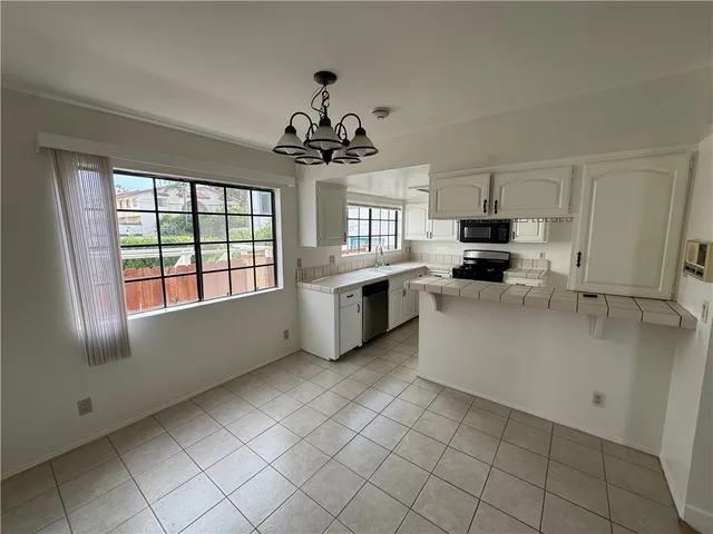 a kitchen with a stove a sink and a microwave
