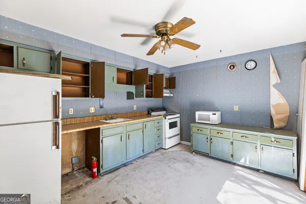 a kitchen with stainless steel appliances a sink stove and refrigerator