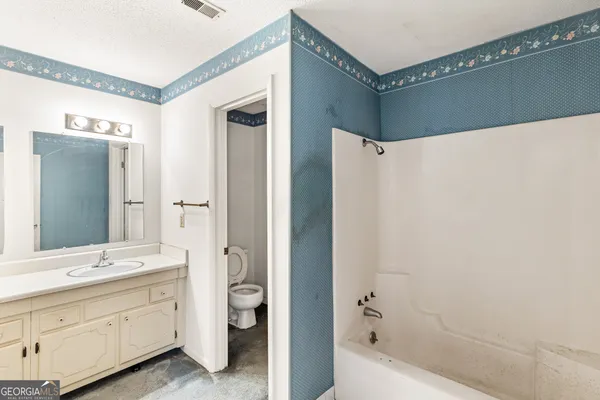 a bathroom with a double vanity sink and mirror with shower