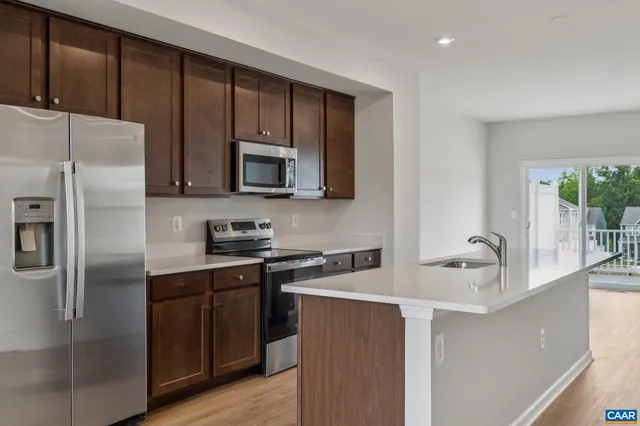 a kitchen with a refrigerator sink and microwave