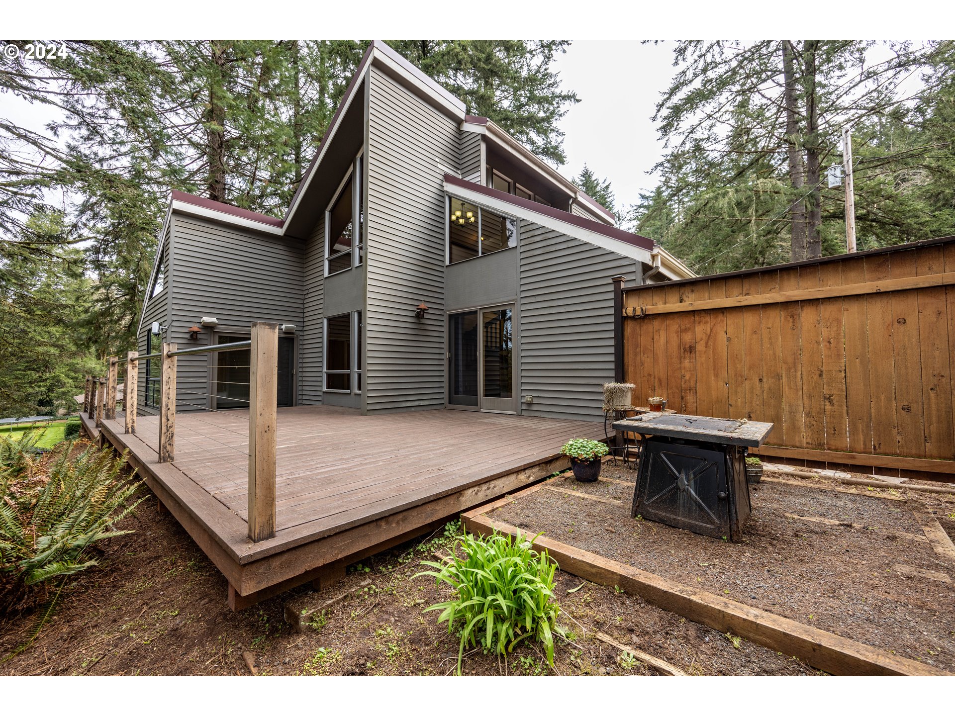39281 Jasper Lowell Road Lowell, OR 97452 - Photo 27 of 37 a view of a patio with table and chairs with wooden fence and plants
