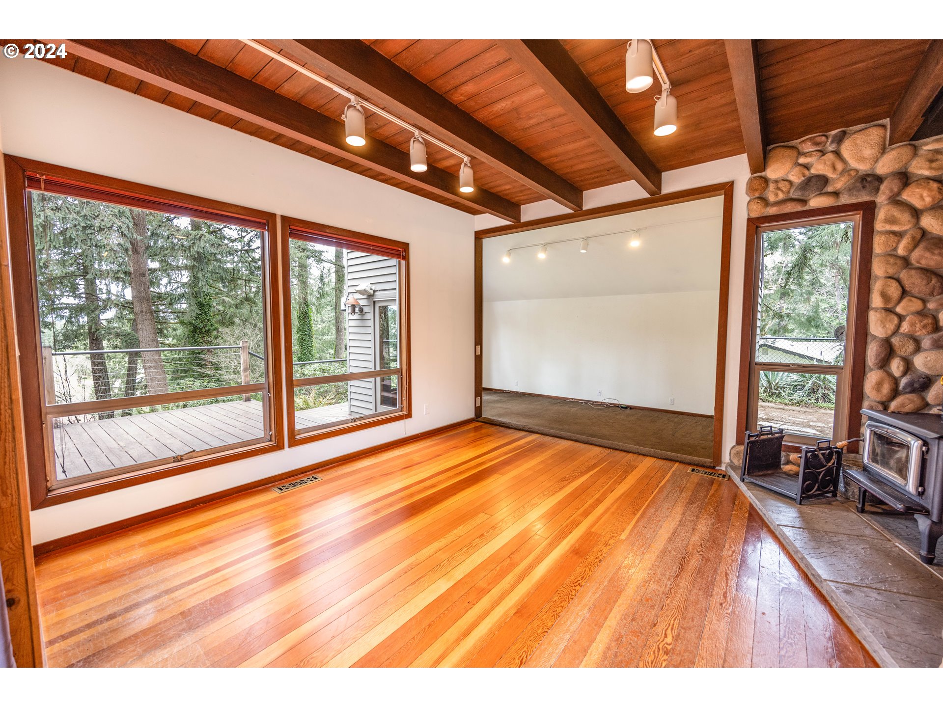 39281 Jasper Lowell Road Lowell, OR 97452 - Photo 7 of 37 a view of an empty room with wooden floor and a window
