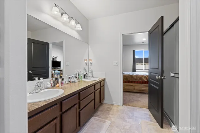 a bathroom with a sink double vanity and a mirror