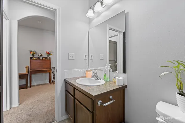 a bathroom with a sink vanity and a mirror