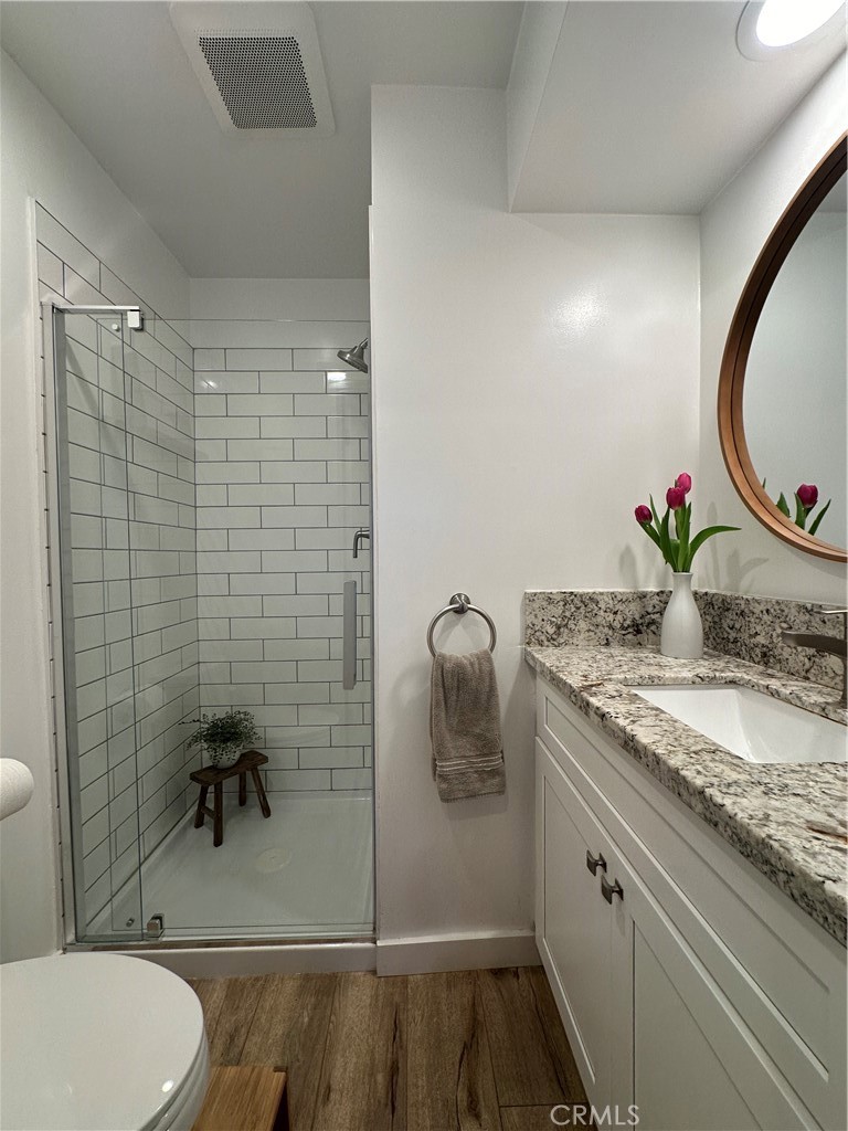 12100 Montecito Road Los Alamitos, CA 90720 - Photo 12 of 25 a bathroom with a granite countertop sink toilet and shower