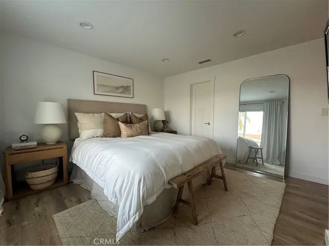 a bedroom with a bed and a night stand