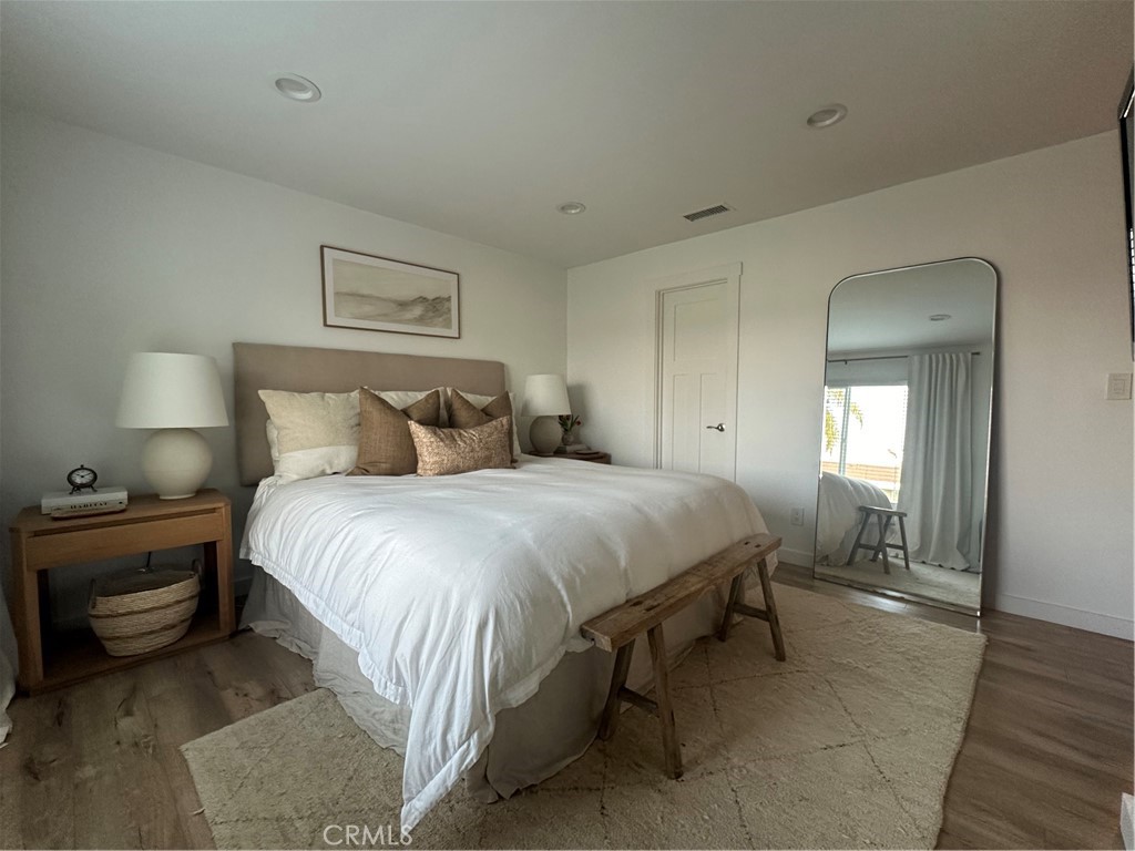 12100 Montecito Road Los Alamitos, CA 90720 - Photo 16 of 25 a bedroom with a bed and a night stand