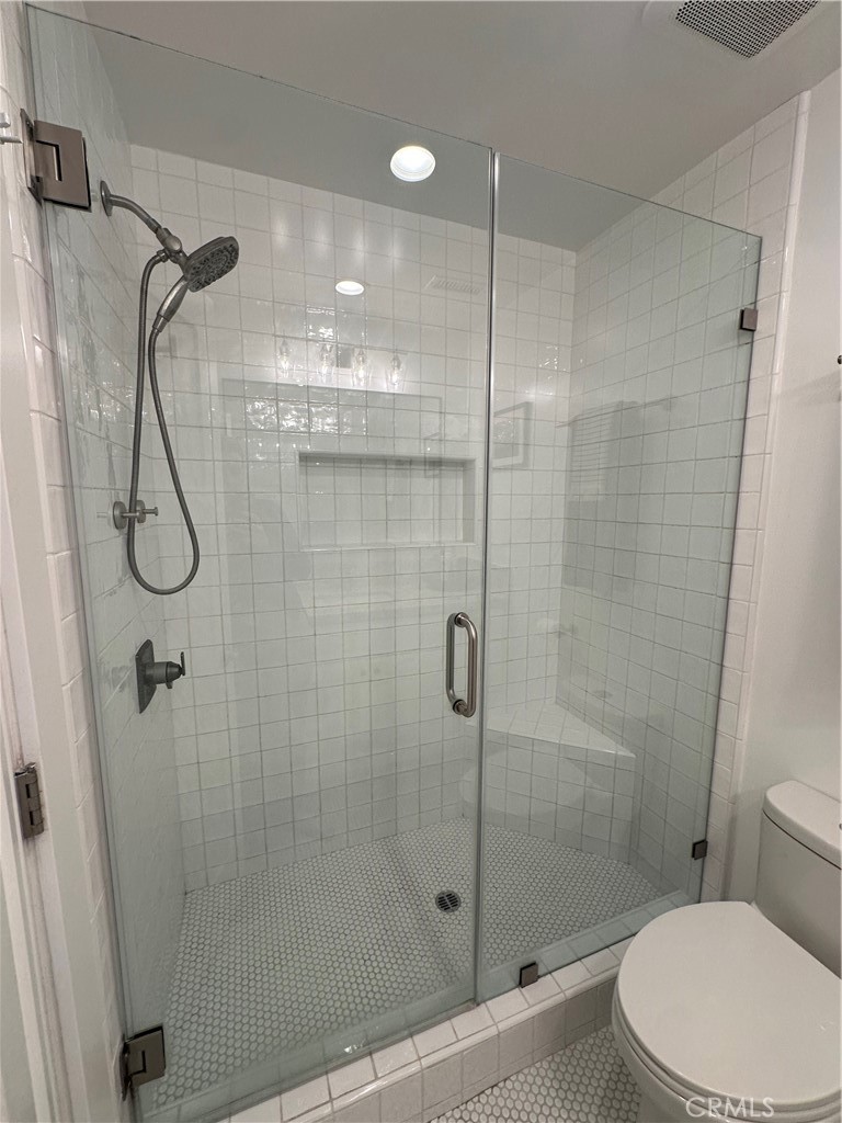 12100 Montecito Road Los Alamitos, CA 90720 - Photo 19 of 25 a bathroom with a shower a toilet and sink