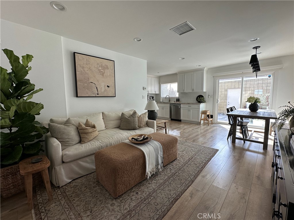 12100 Montecito Road Los Alamitos, CA 90720 - Photo 2 of 25 a living room with furniture potted plant and wooden floor