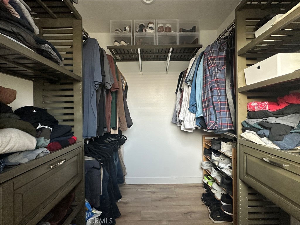 12100 Montecito Road Los Alamitos, CA 90720 - Photo 22 of 25 a view of walk in closet with clothes and shoes