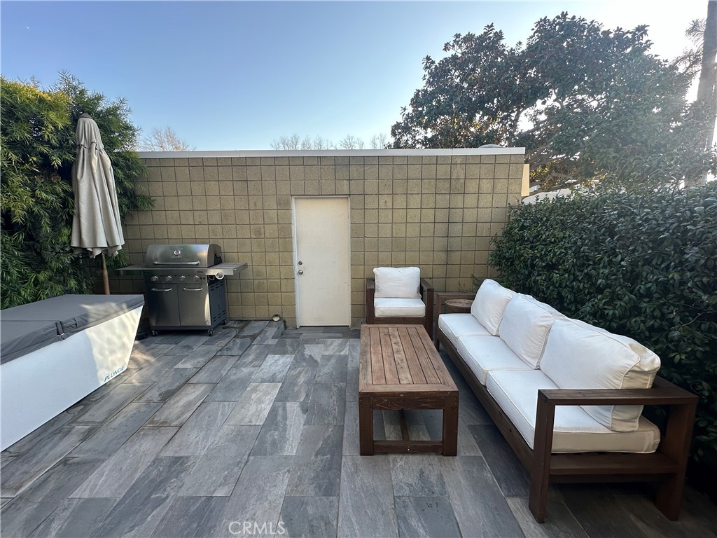 12100 Montecito Road Los Alamitos, CA 90720 - Photo 25 of 25 a view of a patio with couple of chairs and a fire pit