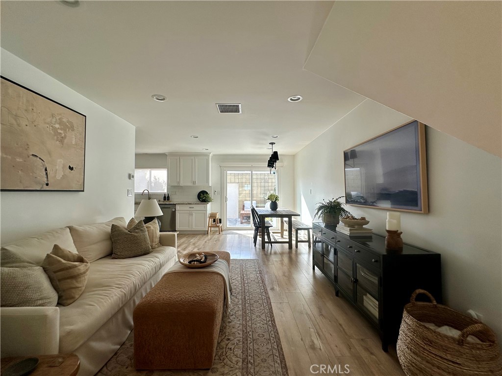12100 Montecito Road Los Alamitos, CA 90720 - Photo 3 of 25 a living room with furniture and a flat screen tv