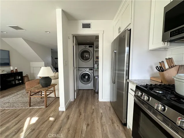a kitchen with stainless steel appliances granite countertop a stove and a refrigerator