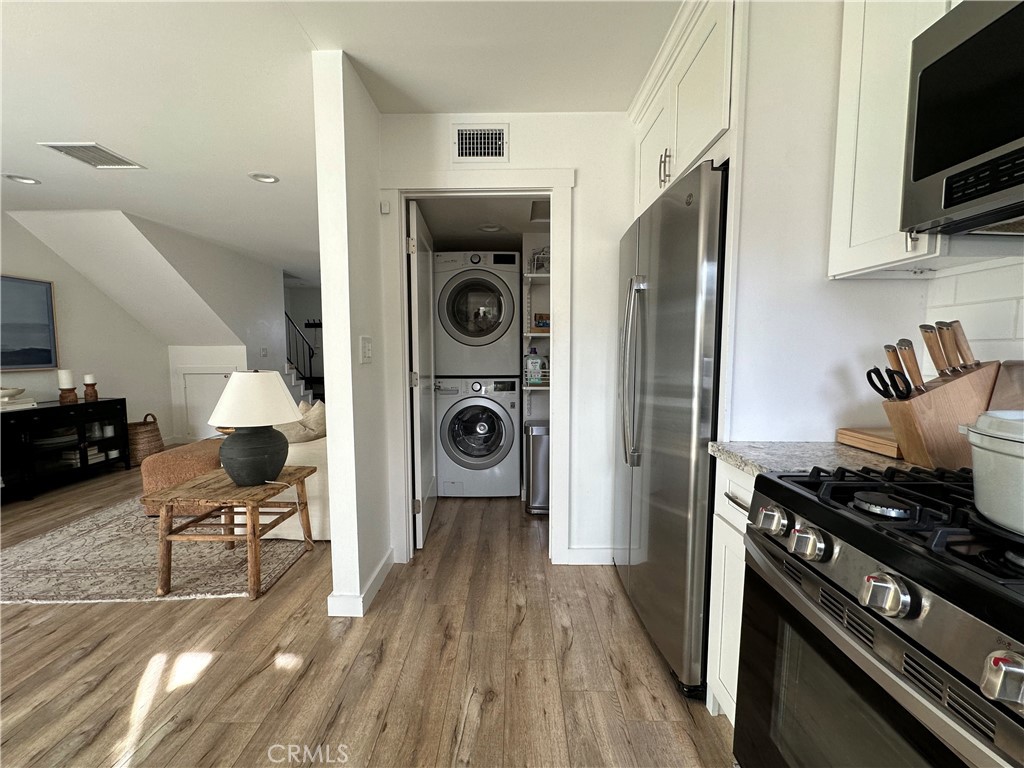12100 Montecito Road Los Alamitos, CA 90720 - Photo 7 of 25 a kitchen with stainless steel appliances granite countertop a stove and a refrigerator