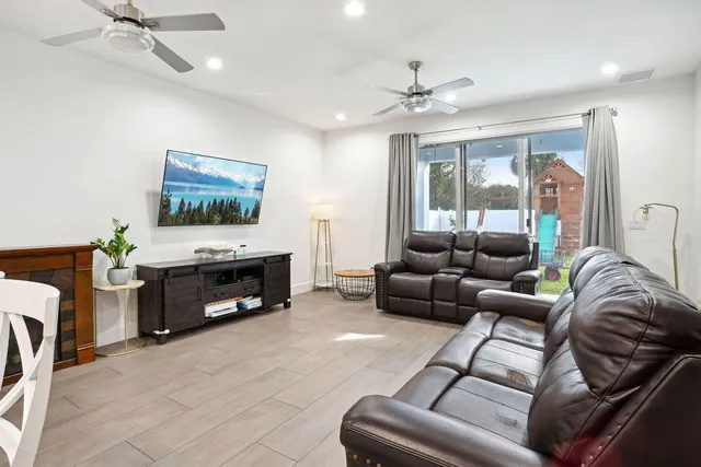 a living room with furniture a fireplace and a flat screen tv