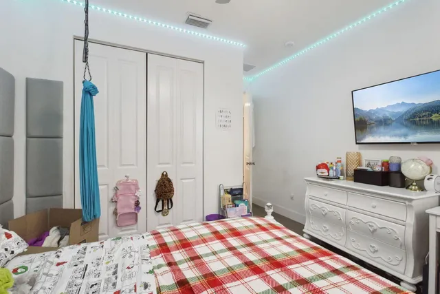 a bedroom with a bed and a dresser