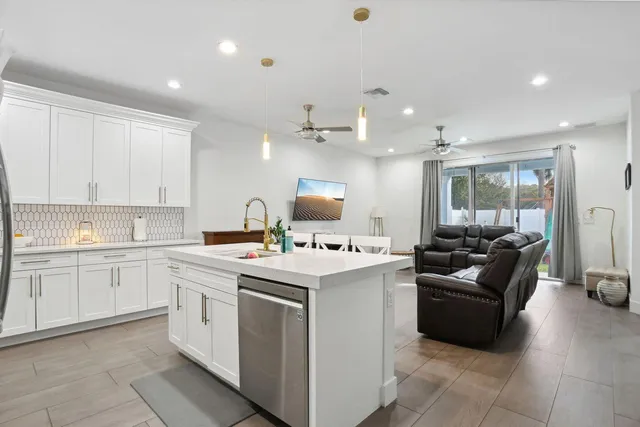 a kitchen with a sink stove and cabinets