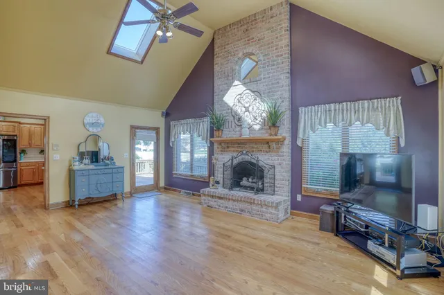 a kitchen with stainless steel appliances granite countertop a kitchen island a stove and a sink