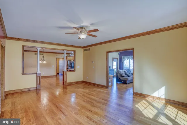 a kitchen with stainless steel appliances granite countertop a refrigerator a sink and wooden floor