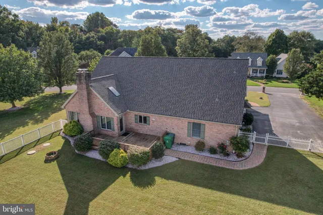 a front view of house with yard and trees in the background