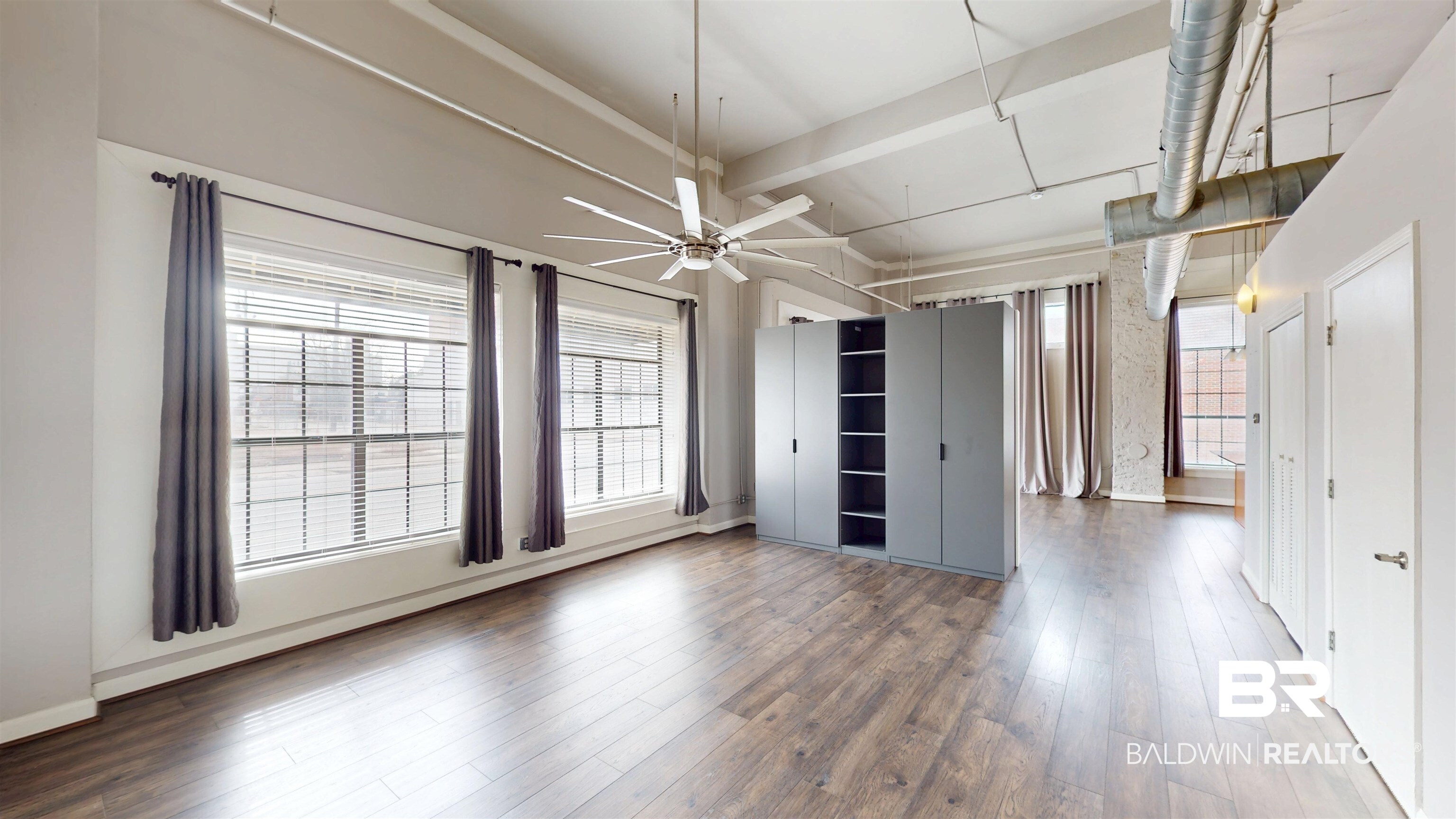 308 St Louis Street, Unit 101 Mobile, AL 36602 - Photo 18 of 30 Unfurnished dining area featuring a ceiling fan, hardwood / wood-style flooring, and beamed ceiling