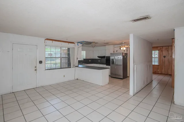 a kitchen with granite countertop a refrigerator and a sink