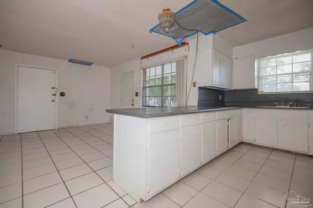 a kitchen with stainless steel appliances granite countertop a sink and a stove
