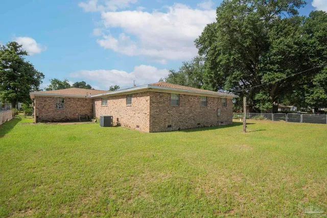 a view of a backyard with a garden and entertaining space