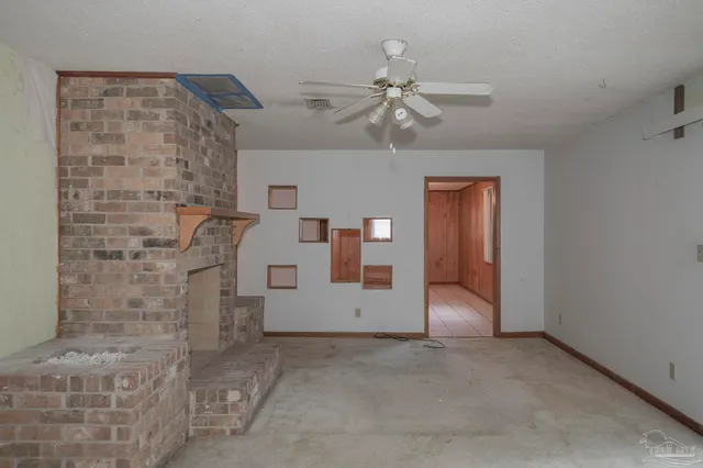 a view of a livingroom with a ceiling fan and window