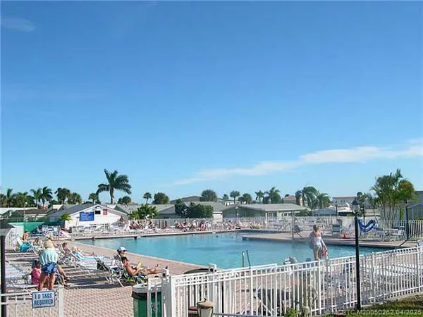 a group of lawn chairs under an umbrella