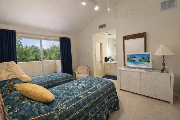 a bedroom with a bed and a large window