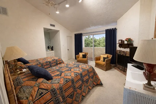 a bedroom with a bed a table and chair