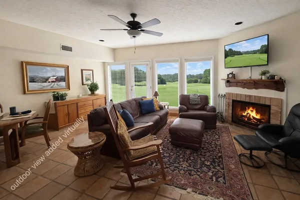 a living room with furniture a flat screen tv and a fireplace