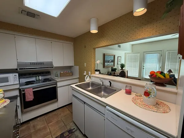 a kitchen with stainless steel appliances granite countertop a sink and cabinets