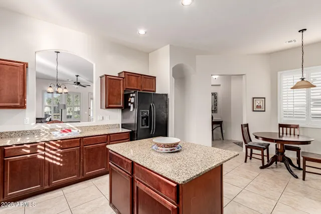a kitchen with a stove a sink and a refrigerator