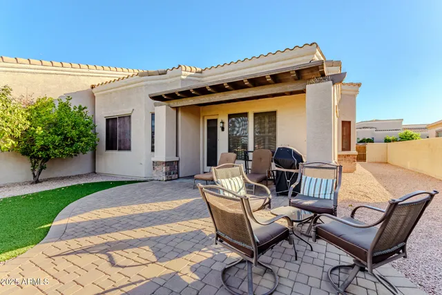 a view of a patio with table and chairs and potted plants