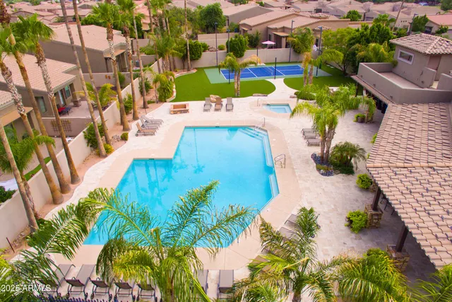 a view of a swimming pool with outdoor seating