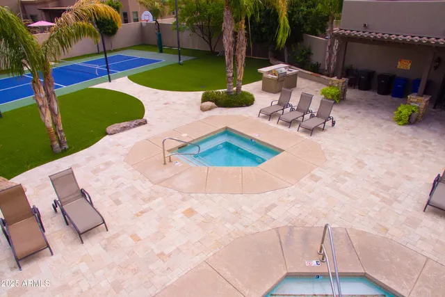 a view of a backyard with swimming pool