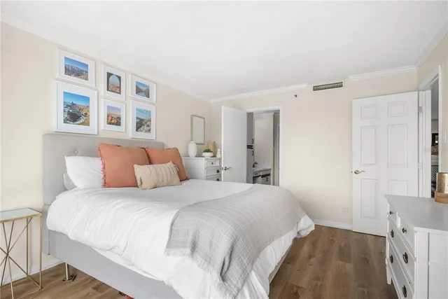 a bedroom with a large bed and a window