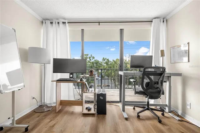a view of a workspace with furniture and a flat screen tv